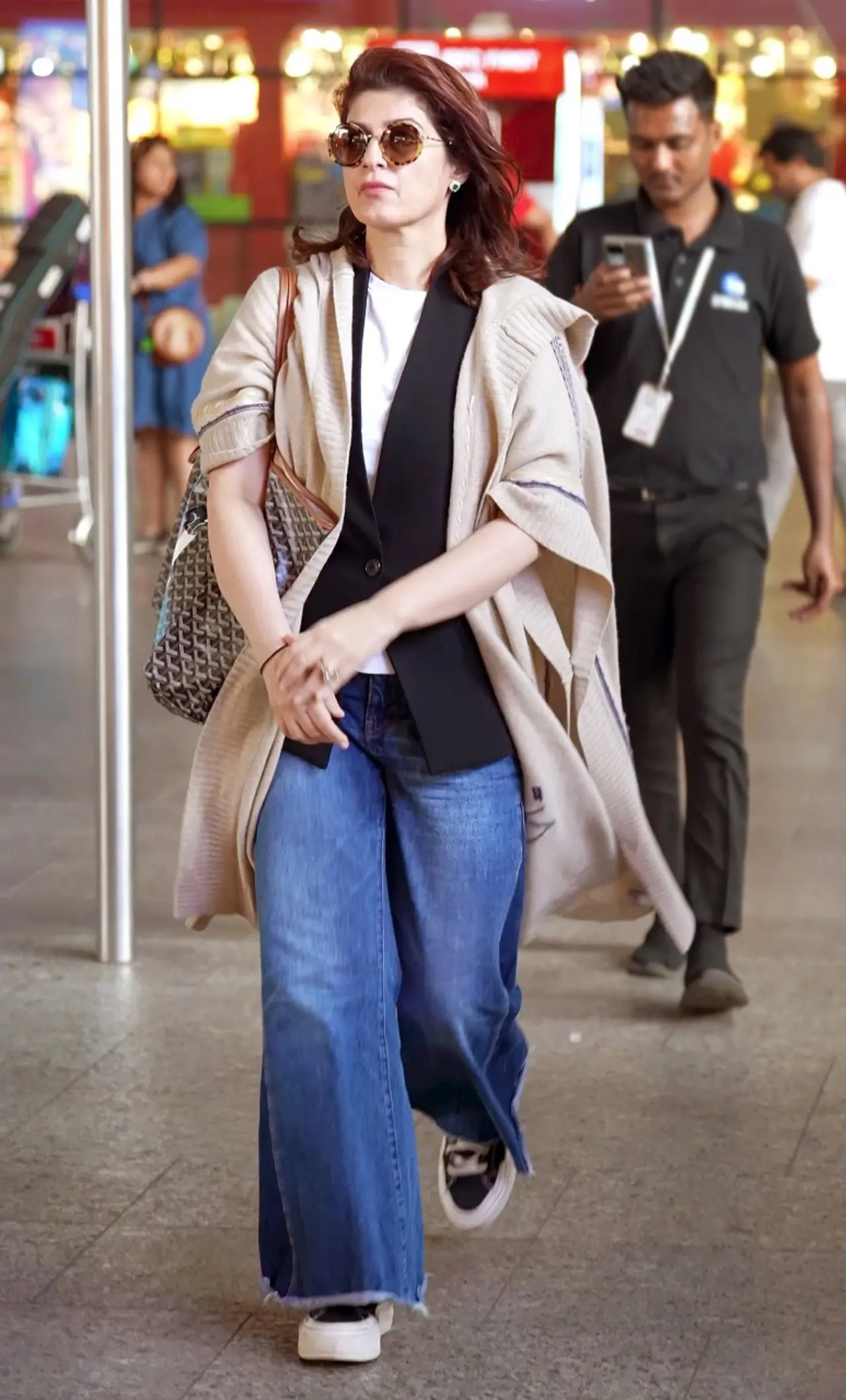 Twinle Khanna looked chic and fashionable as she was spotted at the airport in a blue wide-legged jeans, while her layering and red lips stole the show.